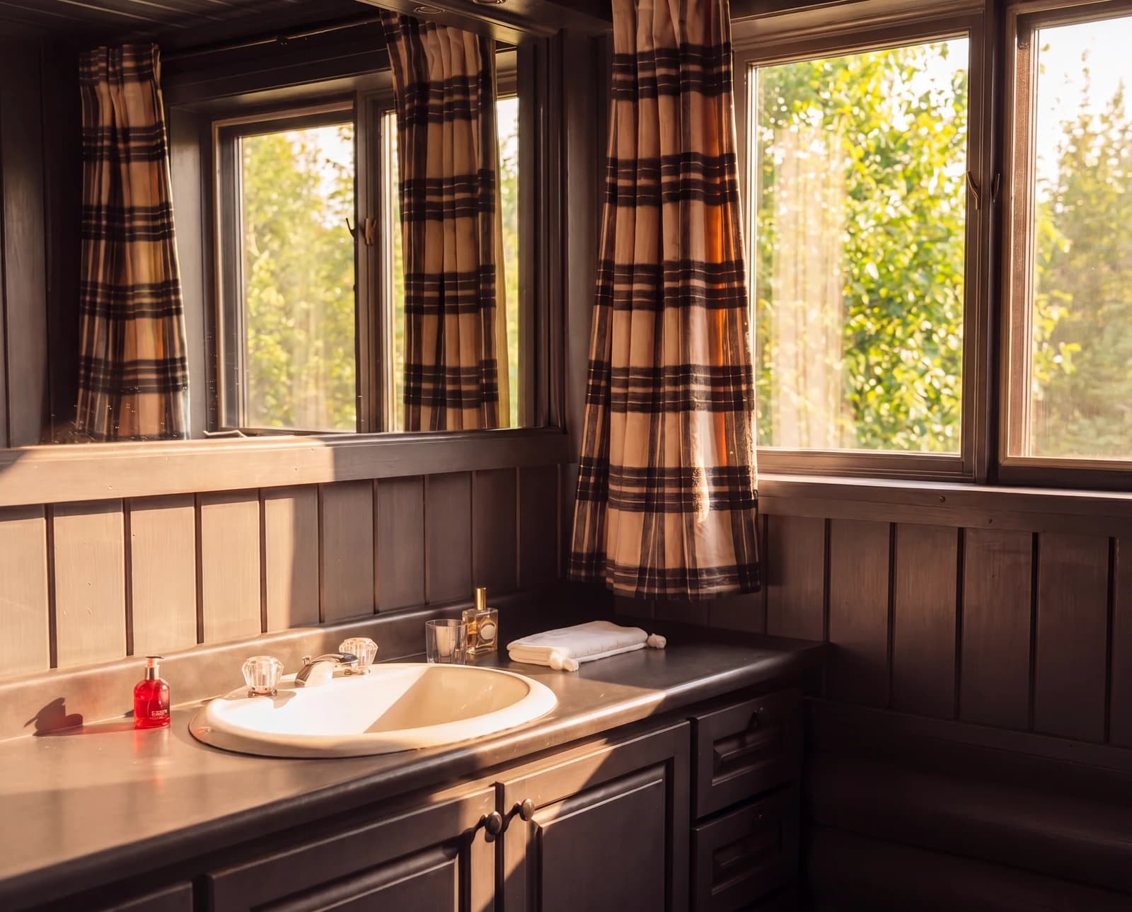 Bright bathroom with sunlight through plaid curtains