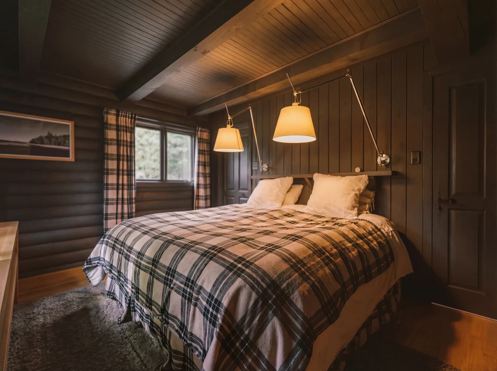 Cozy bedroom with plaid blanket and warm reading lamps