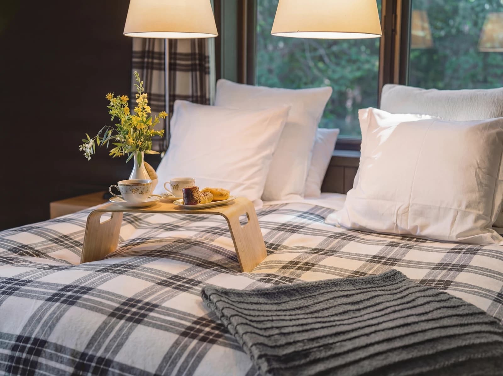 Breakfast tray with flowers on plaid bedding