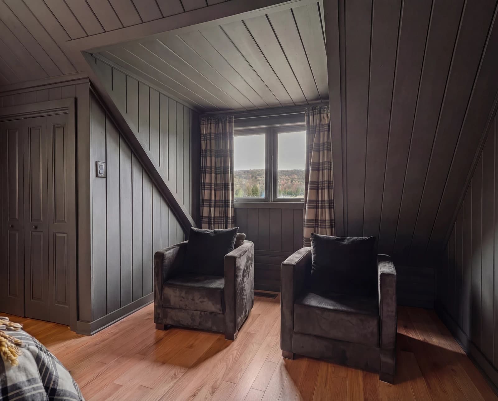 Two velvet armchairs in dormer sitting nook