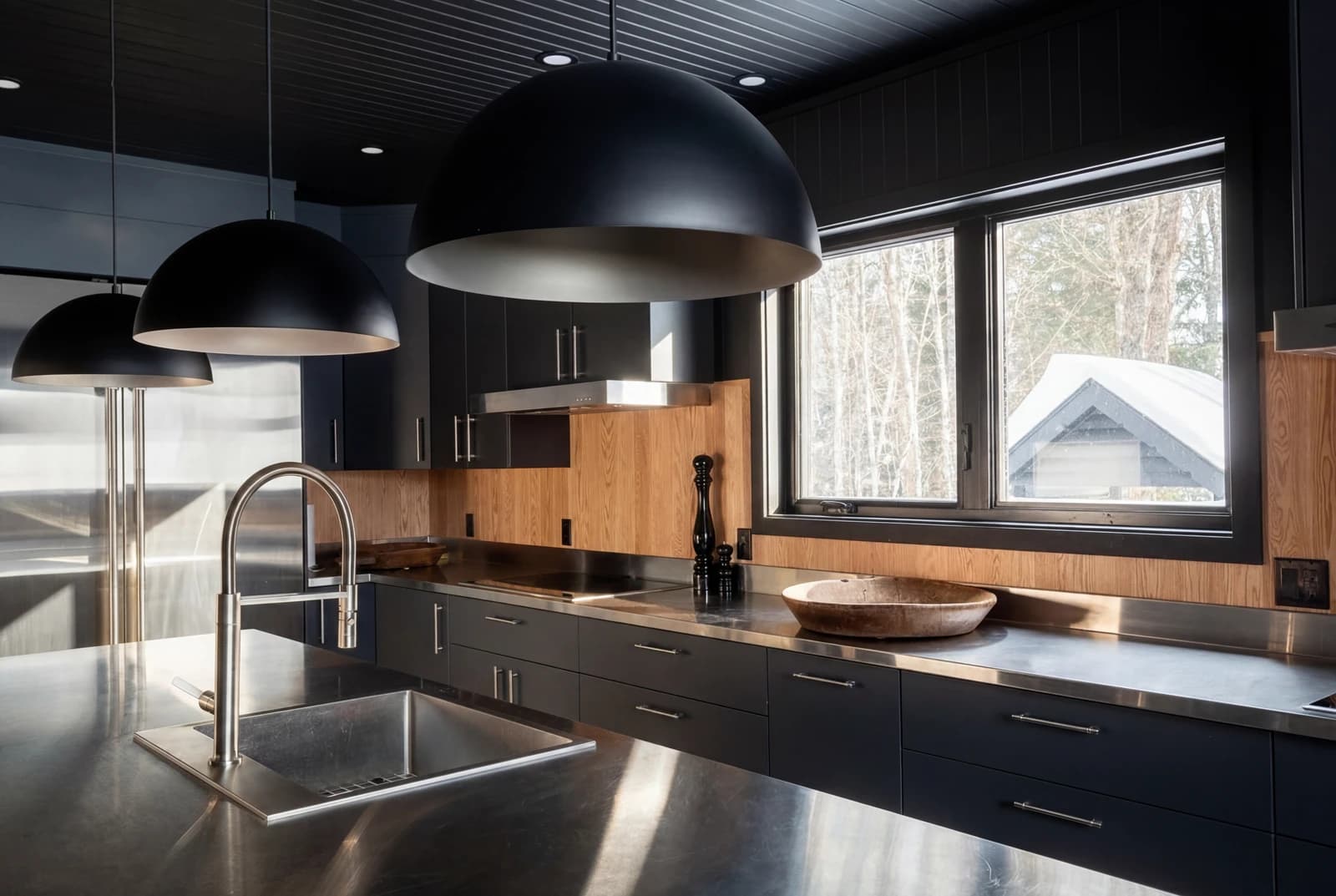 Dark kitchen with island and forest view