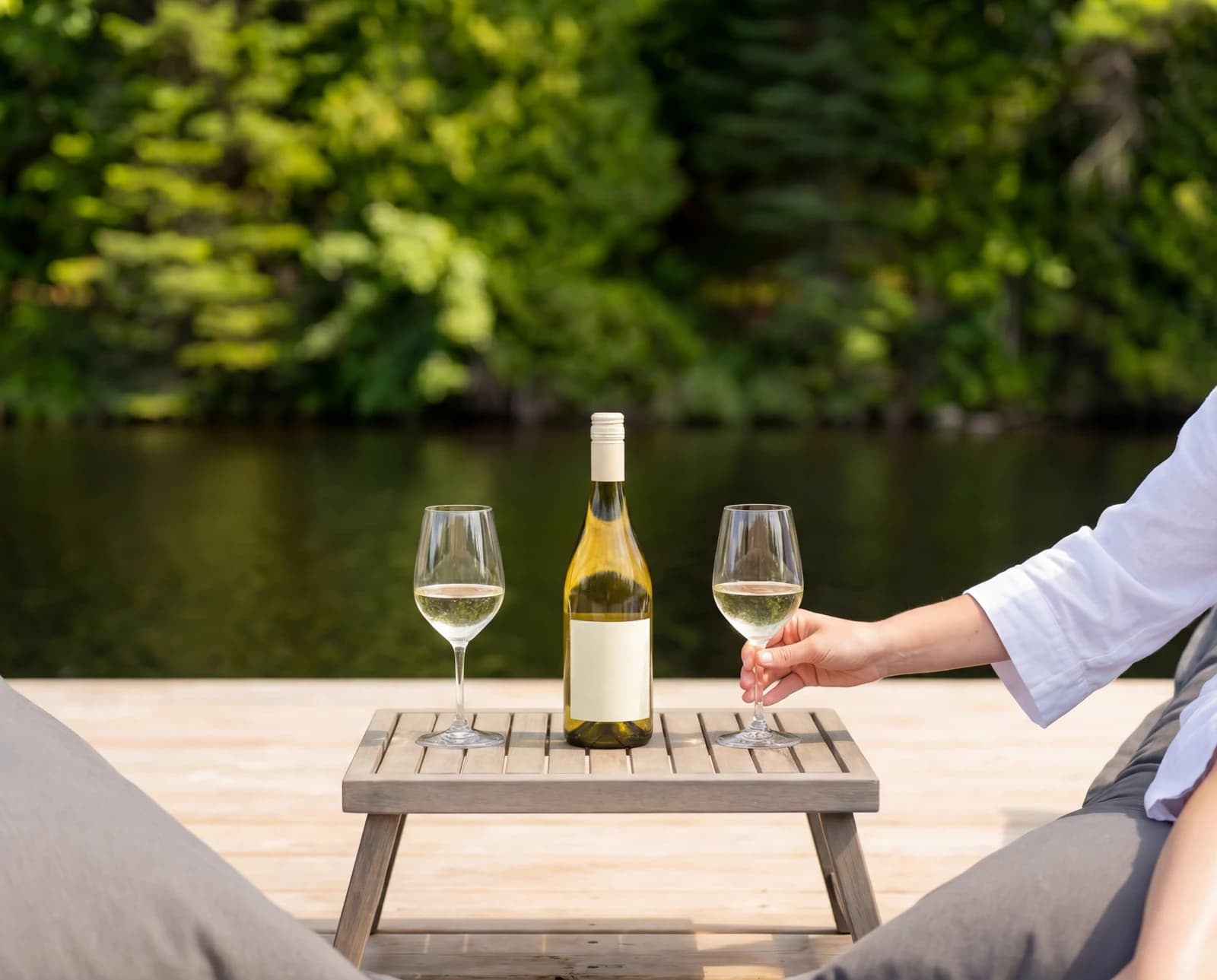 Pouring wine at an outdoor table by the lake